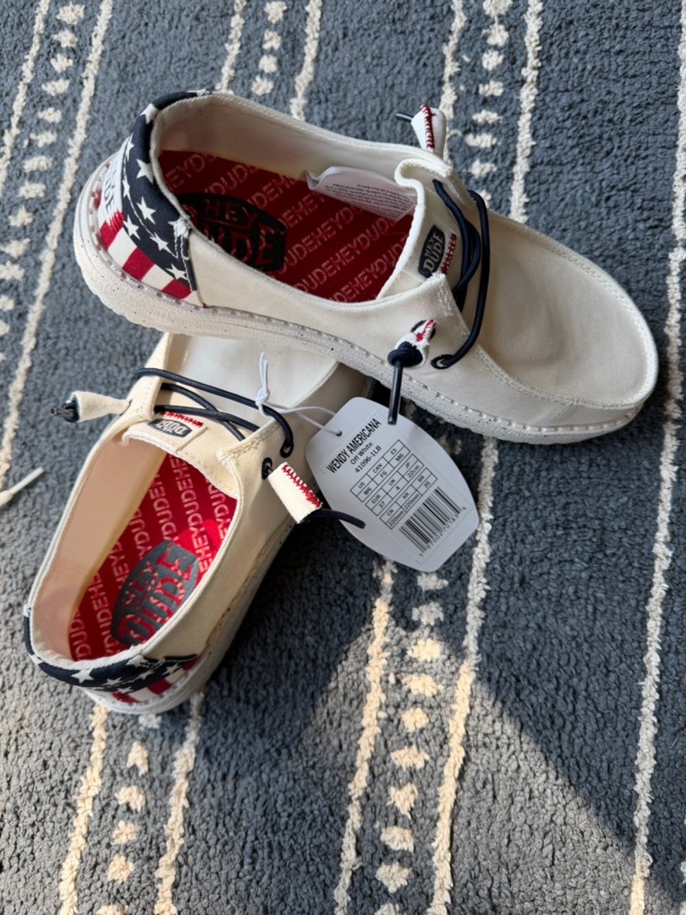 Hey Dude Cream Slip-On Sneakers with Red and Blue Star-Spangled Heel